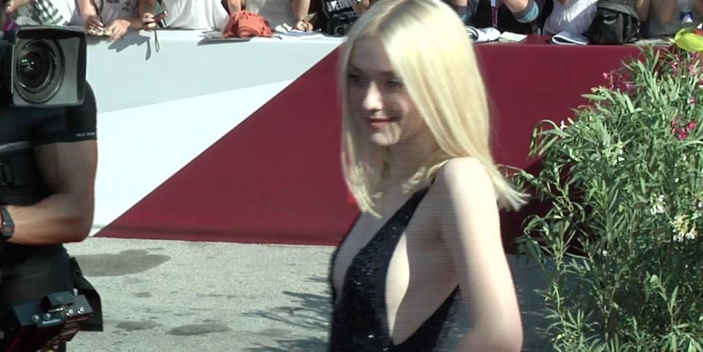 Dakota Fanning posing for photographers and camerapersons on the red carpet at the Venice Film Festival. Freeze frame of video shot by AP Video-journalist Cristina Jaleru. August 31, 2013