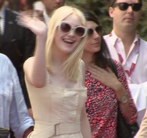 Dakota Fanning waves to fans at the Venice Film Festival. Freeze frame of video shot by AP video journalist Cristina Jaleru. August 31, 2013