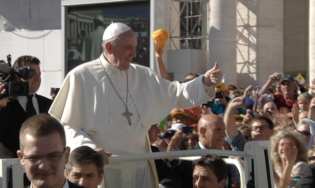 Pope Francis gives the thumbs-up to the crowd during his weekly audience in St. Peter's Square. September 18, 2013. Freeze frame of video shot by AP Television cameraman Gianfranco Stara