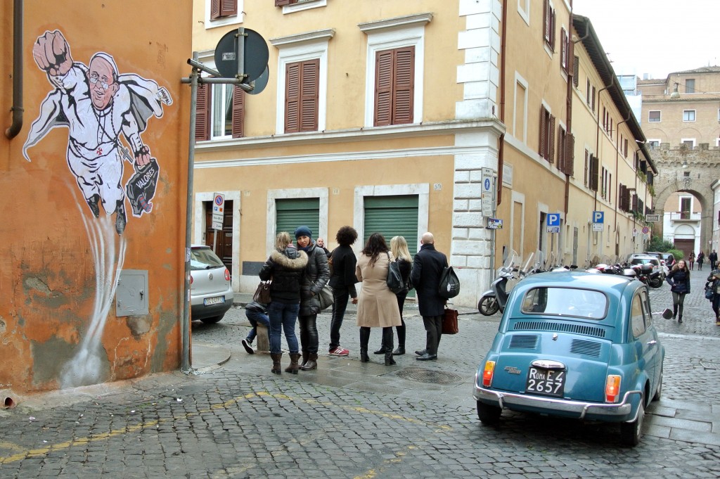 Graffiti showing Pope Francis as Superman on a wall near the Vatican.  Photo by AP Photographer Gregorio Borgia for Mozzarella Mamma. January 29, 2014