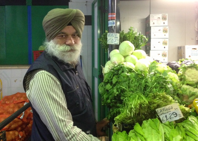 Jagjit from Punjab at his vegetable stand at the Piazza Vittorio market. February 8, 2014. Photo by Trisha Thomas
