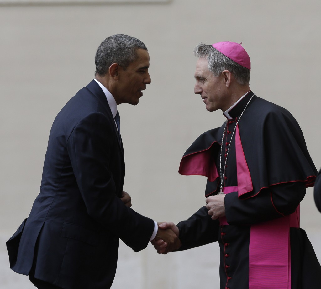 President Obama greets Mons. Georg Ganswein, Prefect of the Papal Household on his arrival at the Vatican. March 27, 2014. Photo by AP photographer Alessandra Tarantino for Mozzarella Mamma.