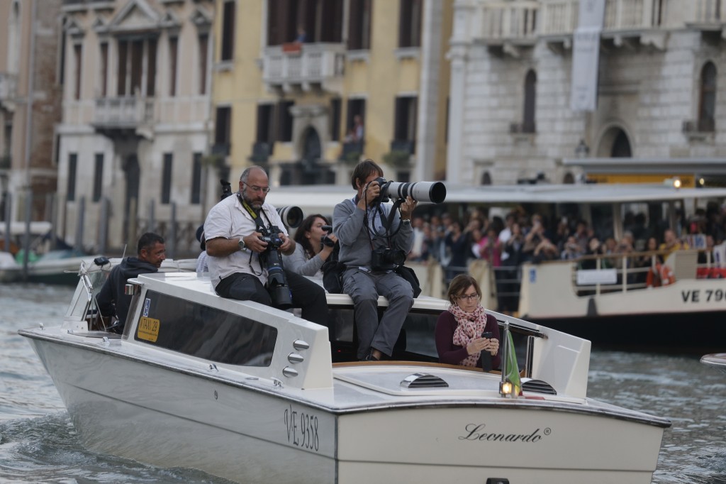 AP's Andrew Medichini, AFP's Andreas Solaro and APTelevision's Trisha Thomas chasing George Clooney down the Grand Canal. September 27, 2014. Photo by Luca Bruno
