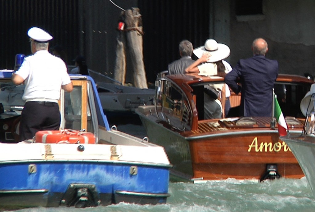 George Clooney and Amal Alamuddin head off in the water taxi called "Amore" and pass under the Rialto Bridge as they leave Venice.  Freeze frame of video shot by Gianfranco Stara. September 29, 2014