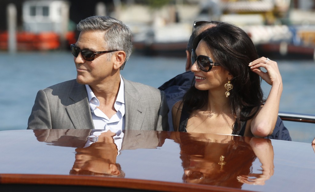 George Clooney and his future bride Amal Alamuddin arrive in Venice, Italy, Friday, Sept. 26, 2014.