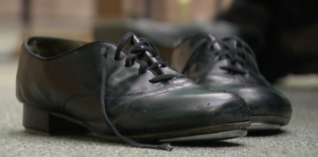 Father David Rider's well-worn tap dancing shoes waiting for him to put them on.  Freeze frame of video shot by Paolo Lucariello. October, 2014