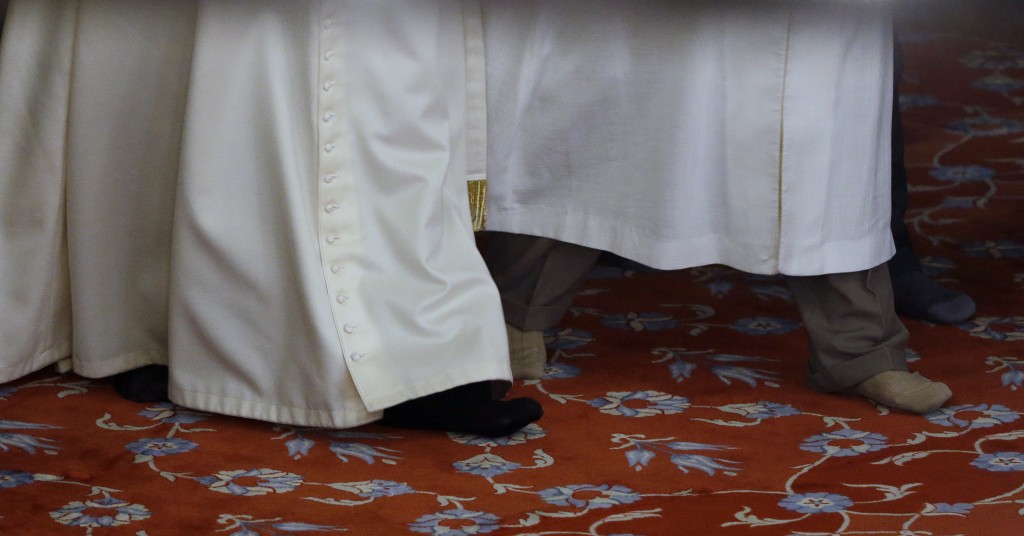 Pope Francis in black socks and Grand Mufti in brown socks as they make their way across the Blue Mosque.  Photo by AP photographer Gregorio Borgia for Mozzarella Mamma. November 29, 2014