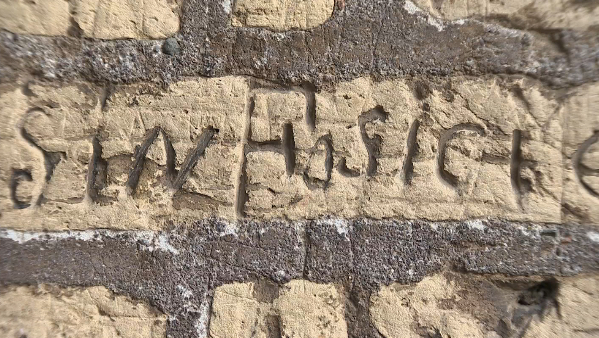 A name etched into one of the outer walls of the Colosseum by vandals years ago. Freeze frame of video shot by AP cameraman Gigi Navarra. November 26, 2014