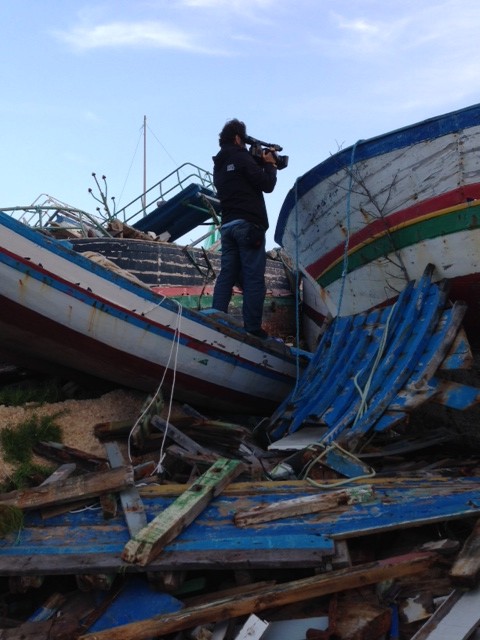 Associated Press video-journalist Paolo Santalucia filming the boat graveyard on the Italian island of Lampedusa. November 11, 2014. Photo by Trisha Thomas