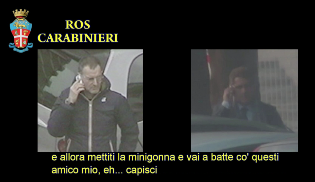 Freeze frame of police video showing Massimo Carminati on the left talking on the phone with Salvatore Buzzi on the right.
