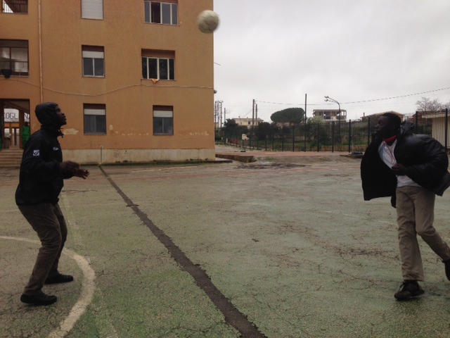 Two young migrants playing soccer at "Umberto I" holding center in Siracusa, Sicily. March 24, 2015. Photo by Trisha Thomas