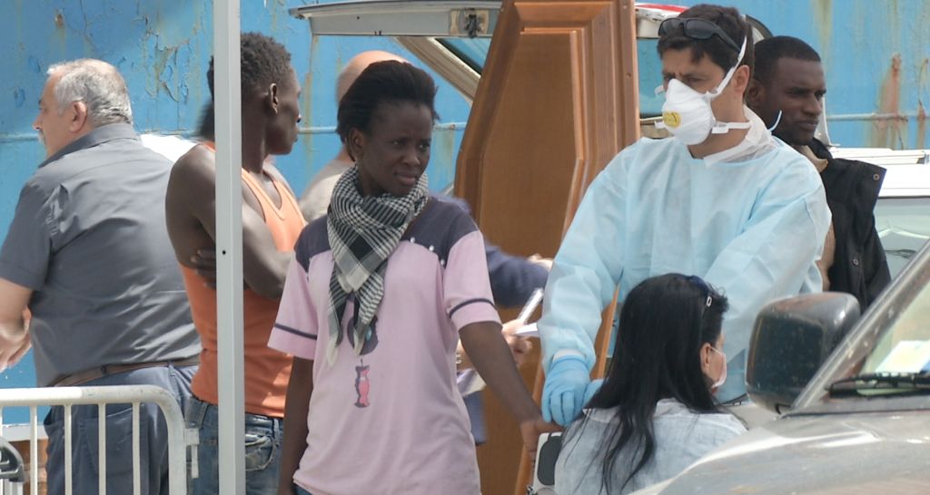 Astou Dia Fall, a 24-year-old migrant from Senegal gets her fingerprint taken when she arrives in the port of Catania, Sicily. May 5, 2015. Freeze frame of video shot by AP Television Video-Journalist Andrea Rosa. May 5, 2015