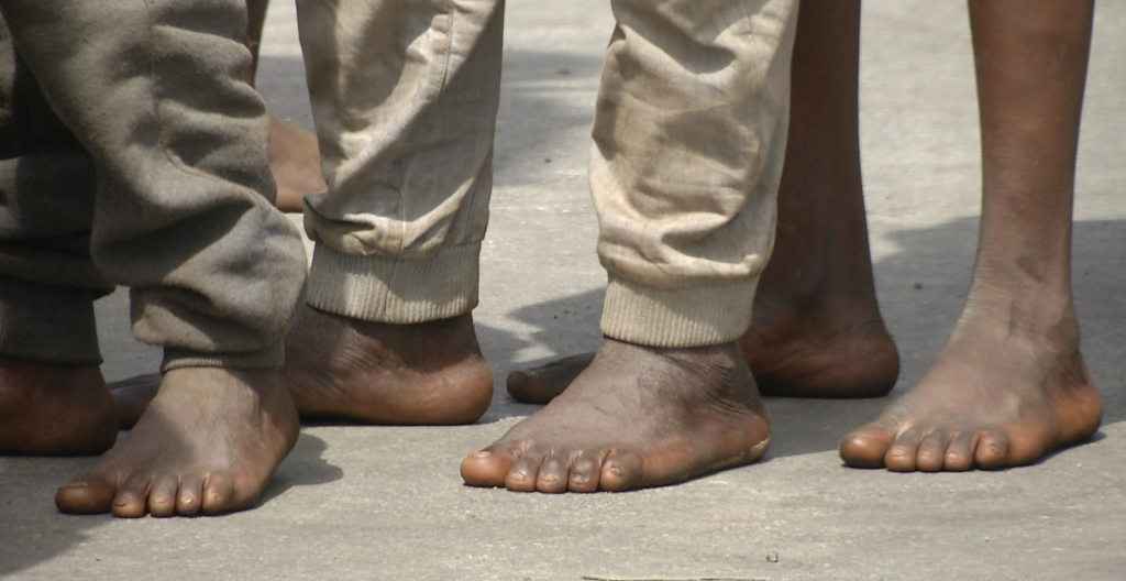 Barefoot migrants just after they have arrived in the port of Catania, Sicily. May 5, 2015. Freeze frame of video shot by AP Television Cameraman Andrea Rosa