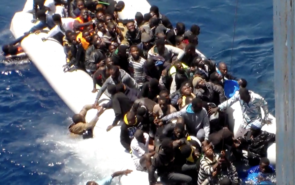 Chaos aboard deflating rubber dinghy as migrants try to get to safety on merchant ship. Freeze frame of video shot by Polish seaman. May 2015 (Video belong to AP archive -www.aparchive.com )