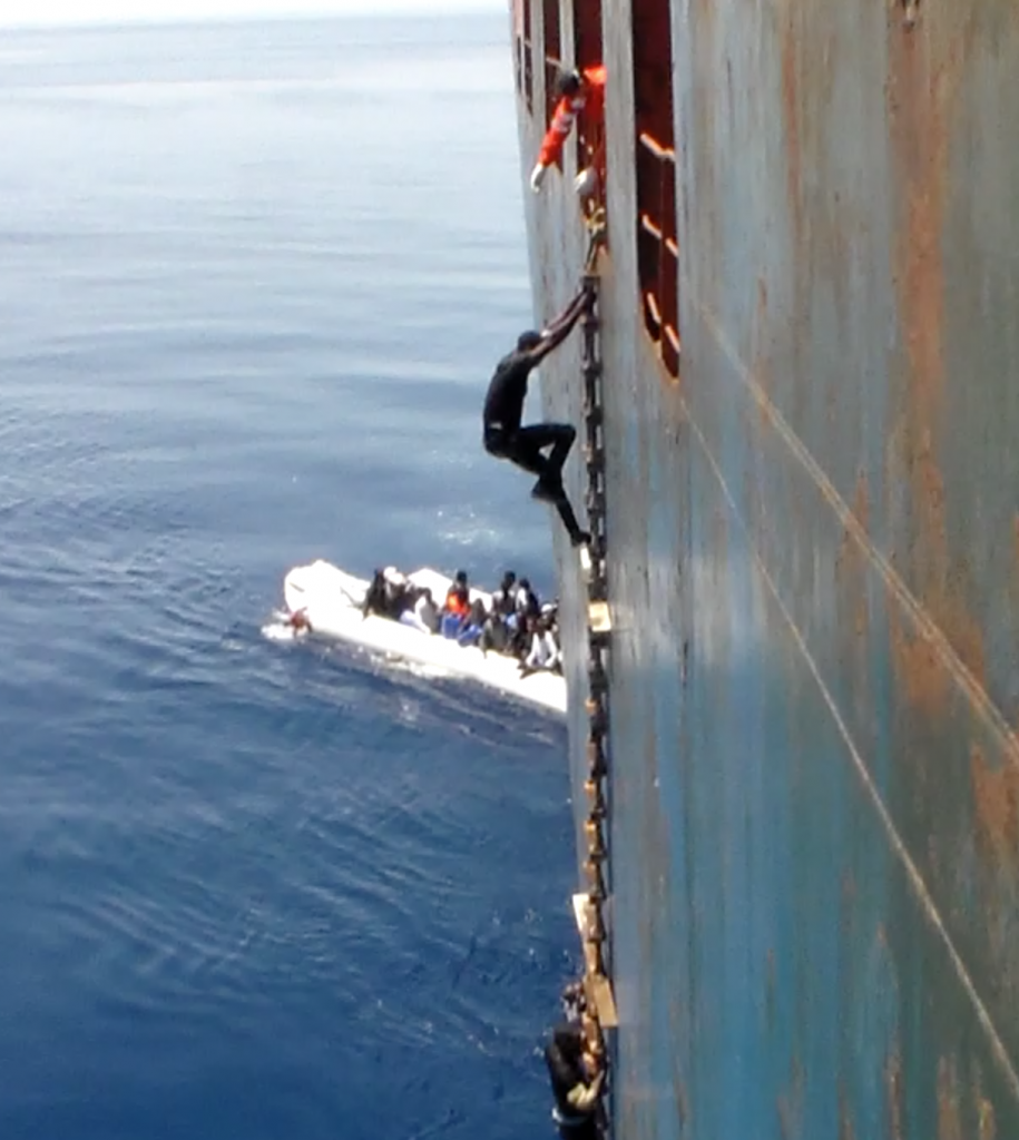 Migrant climbing up ladder to safety aboard the merchant ship Zeran. Freeze frame of video shot by Polish seaman. May 2015. (video copyright AP archive - www.aparchive.com )