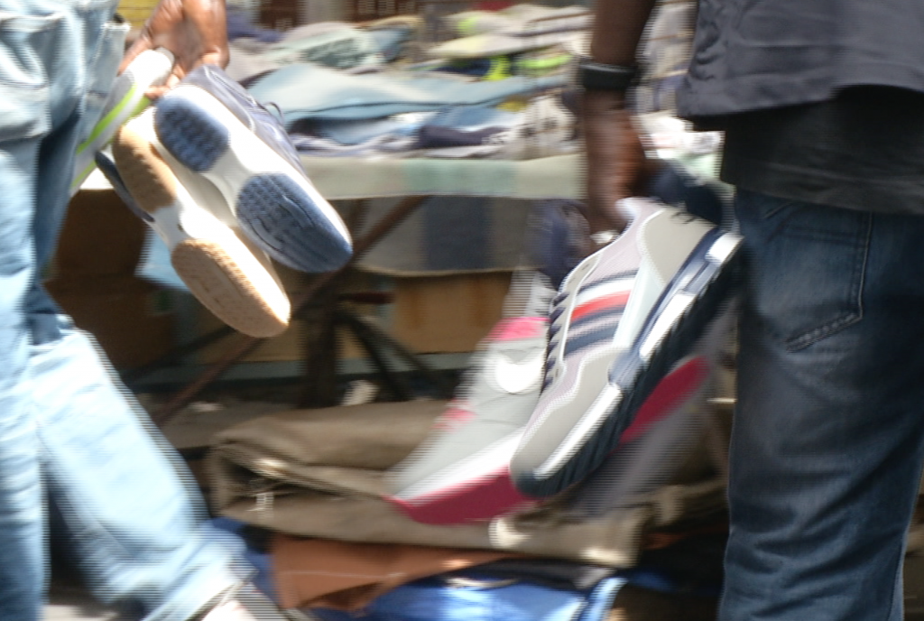 Counterfeit sneakers being sold by men in the main market in Catania, Sicily. May 7, 2015.  Freeze frame of video shot by AP video-journalist Andrea Rosa