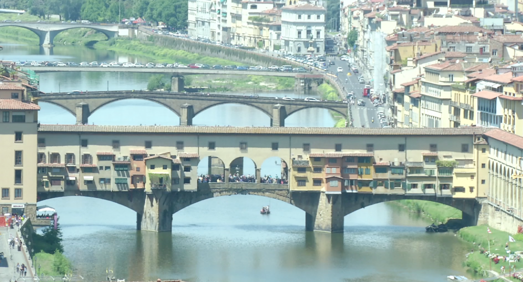 Ponte Vecchio -- The famous bridge stretching over the Arno River in Florence. Note the Vasari Corridor, the secret passageway that runs along the top, that Robert Langdon and Sienna Brooks use to escape their pursuers. Freeze Frame of video shot by AP Cameraman Pietro De Cristofaro. Florence, May 11, 2015