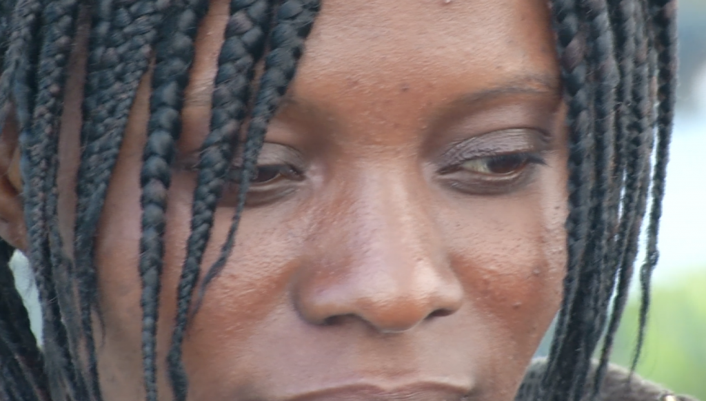 Freeze frame of close up of Silla Zelia, a 23-year-old migrant from the Ivory Coast. Video shot by AP Television cameraman Luigi Navarra. April 21, 2015