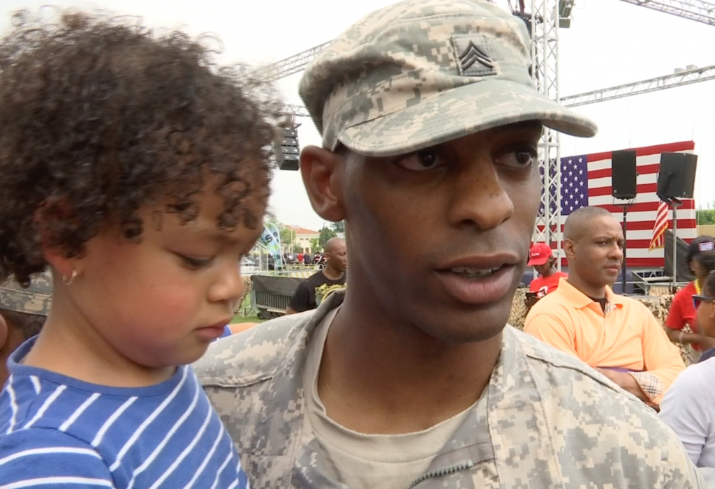 Arlington Chandler and his little girl shortly after listening to First Lady Michelle Obama at the US Army Garrison at Vicenza. June 19, 2015. Freeze Frame of video shot by AP Cameraman Gigi Navarra.