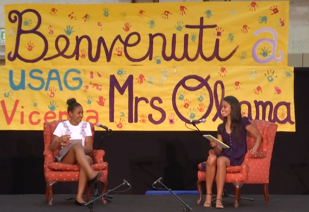 Sasha (left) and Malia (right) Obama read out loud to children at the US Army Garrison in Vicenza Italy. June 19, 2015. Freeze frame of video shot by AP Cameraman Gigi Navarra