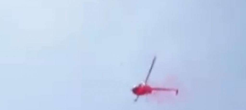 Helicopter flies low over Rome releasing rose petals over the funeral over clan boss Vittorio Casamonica. August 20, 2015. Freeze frame of video.