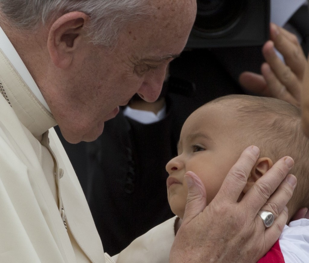Pope Francis caresses a baby during his weekly audience in St. Peter's Square. September 2, 2015. Photo by AP Photographer Alessandra Tarantino for Mozzarella Mamma