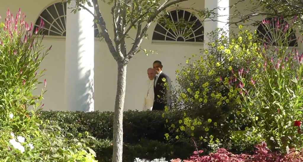 President Obama and Pope Francis walk past the Rose Garden at the make their way to the Oval Office. Freeze frame of video shot by Trisha Thomas for AP Television. September 23, 2015