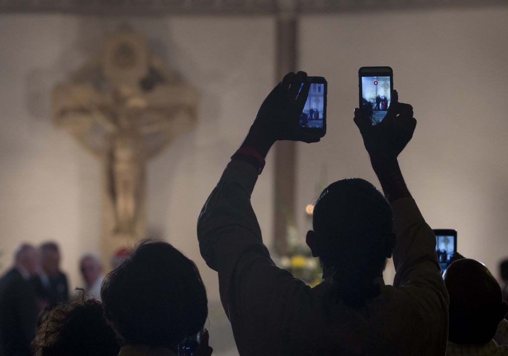 People raising their cell phones to take a photo of Pope Francis at St. Patrick's Church in Washington. September 24, 2015. Photo by AP Photographer Alessandra Tarantino for Mozzarella Mamma