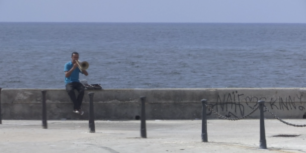 A Cuban man on the Malecon seawall playing the trumped all by himself. Freeze frame of video shot by AP video-journalist Paolo Santalucia. September 20, 2015