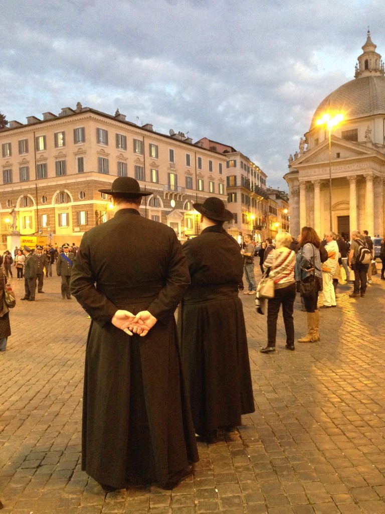 Two priests in "cappelli romani" watching the Finance Police marching band in Piazza del Popolo. November 5, 2015 Photo by Trisha Thomas