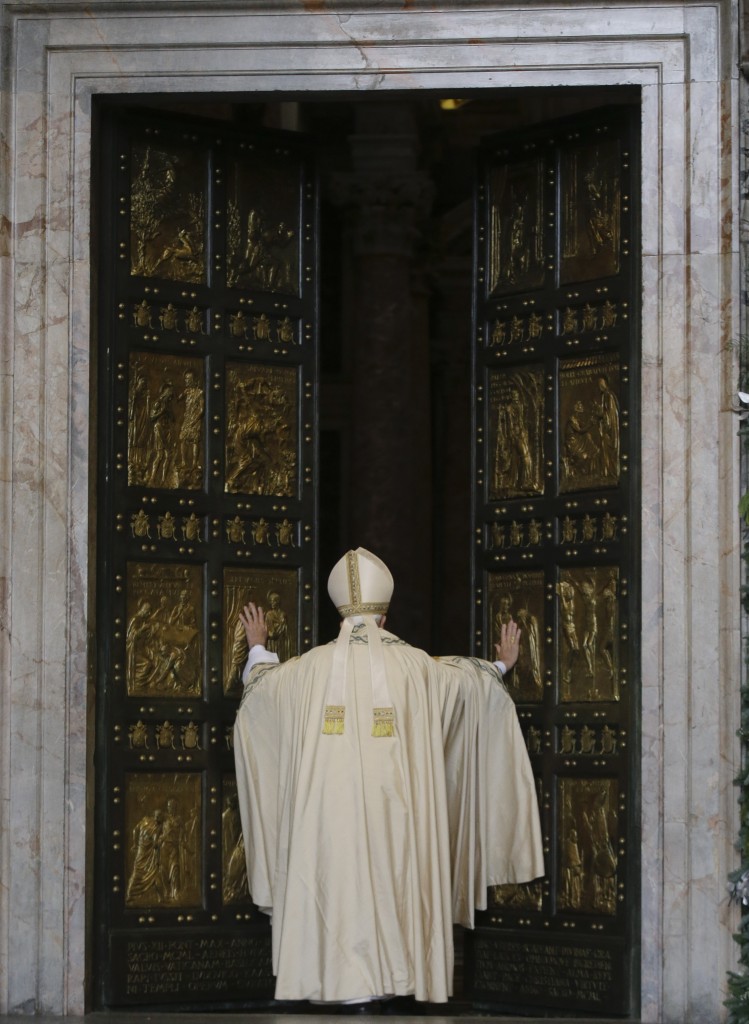 Pope Francis pushes open the Holy Door on St. Peter's Basilica. December 8, 2015. Photo by AP Photographer Gregorio Borgia