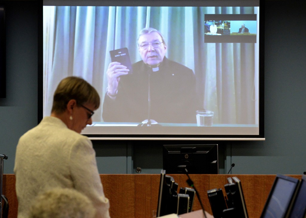 Cardinal George Pell swears on bible at opening of testimony to Royal Commission, Monday 29 Feb, 2016 during a video link from Rome, Italy at the Royal Commission into Institutional Responses to Child Sexual Abuse hearing. Photo Jeremy Piper (Photo handout from Royal Commission on Child Abuse)