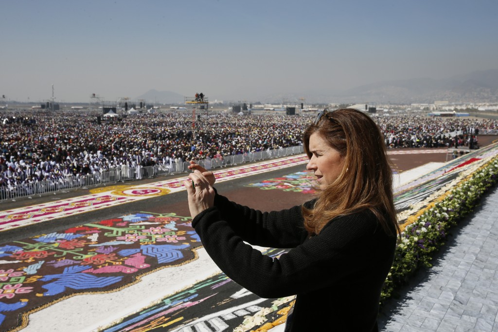 Trisha Thomas taking a picture of crowd at Papal Mass in Ecatepec, Mexico. Photo by Paul Haring of Catholic News Service. February 14, 2016