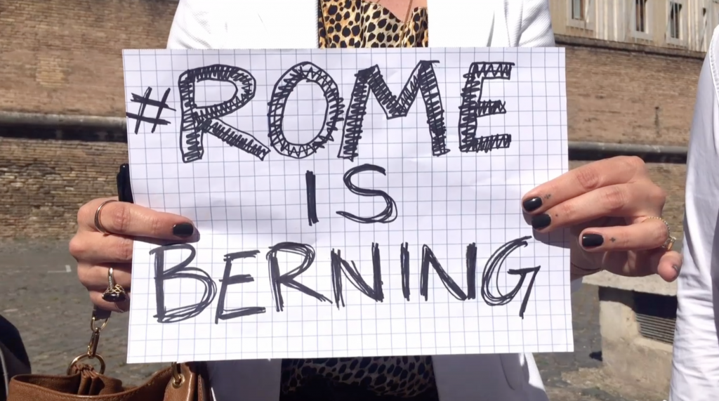 Sign in hands of a Bernie Sanders supporter in Rome. Freeze frame of video shot by AP Television Cameraman Luigi Navarra, April 15, 2016