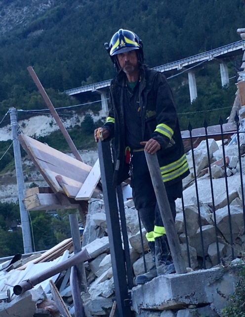 Firefighter Danilo Dionisi, one of the first people we saw on entering Pescara Del Tronto. Behind him you can see the highway embankment where we first stopped to film. August 24, 2016. Photo by Trisha Thomas