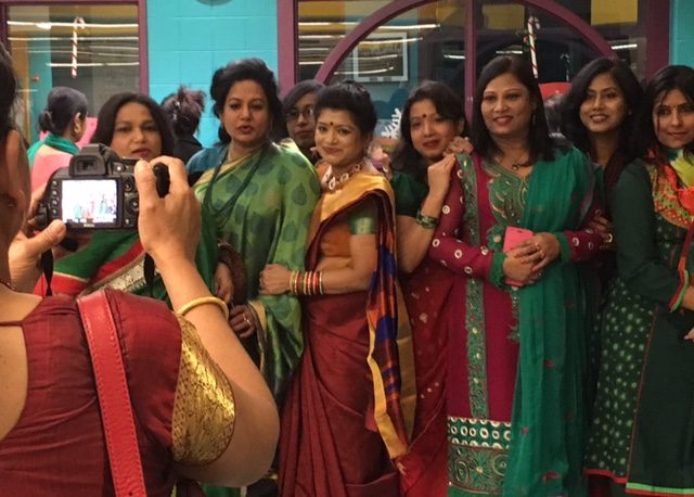 Bangladeshi women in gorgeous silk saris and shiny bangles pose proudly for a photo at a celebration of the 45th anniversary of Bangladesh's Victory Day in Boston. December 17, 2016. Photo by Trisha Thomas