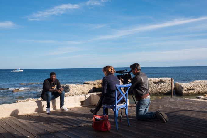 Marc Samie, a 21-year-old migrant from Togo, tells his dramatic personal story in an interview for AP Television with Trisha Thomas and cameraman Gino Maceli in the fishing village of Marzamemi, Sicily. November 11, 2016