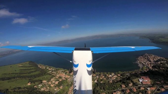 Lake Bracciano and the lakeside town of Anguillara seen under the right part of the wing of the little Allegro airplane. Photo by Chris Warde-Jones
