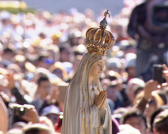 Statue of Our Lady of Fatima being carried through the crowd. Freeze frame of Host Broadcaster pool video. Fatima, Portugal May 13, 2017
