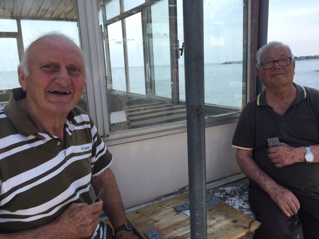 Salvatore and Carmelo Cannizzaro play briscola, a popular Italian card game, in front of a coffee bar along the beach in Giardino Naxos. Photo by Trisha Thomas, May 25, 2017