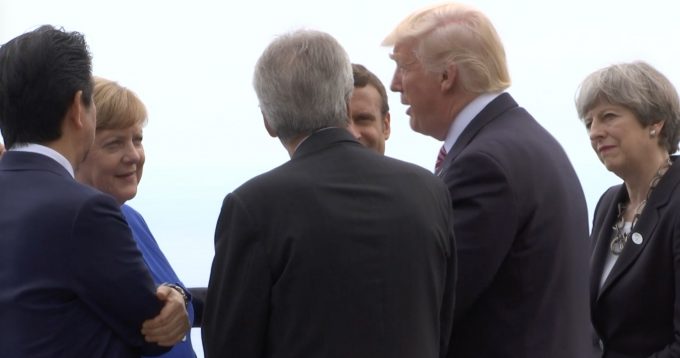 G7 leaders listen as US President Donald Trump appears to be telling a joke as they stop at a lookout point in Taormina during the G7 Summit. May 26, 2017. Freeze frame of video shot by Associated Press Television Video-Journalist Helena Alves.