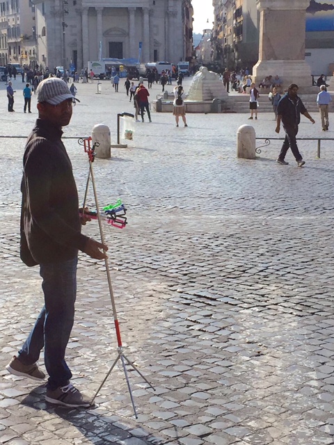 Young man selling selfie-sticks at Piazza del Popolo, October 2017